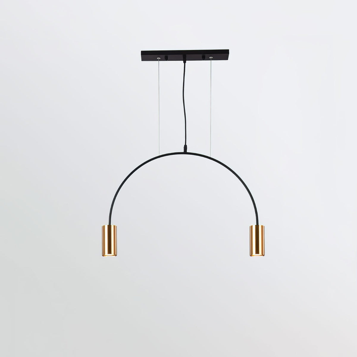 One arch with two brass spot heads hangs below a slim black canopy bar on this Clérachic pendant.
