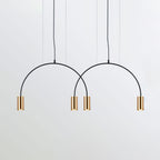 Two black arches and four brass spot heads, this Clérachic pendant seen against a pale backdrop.