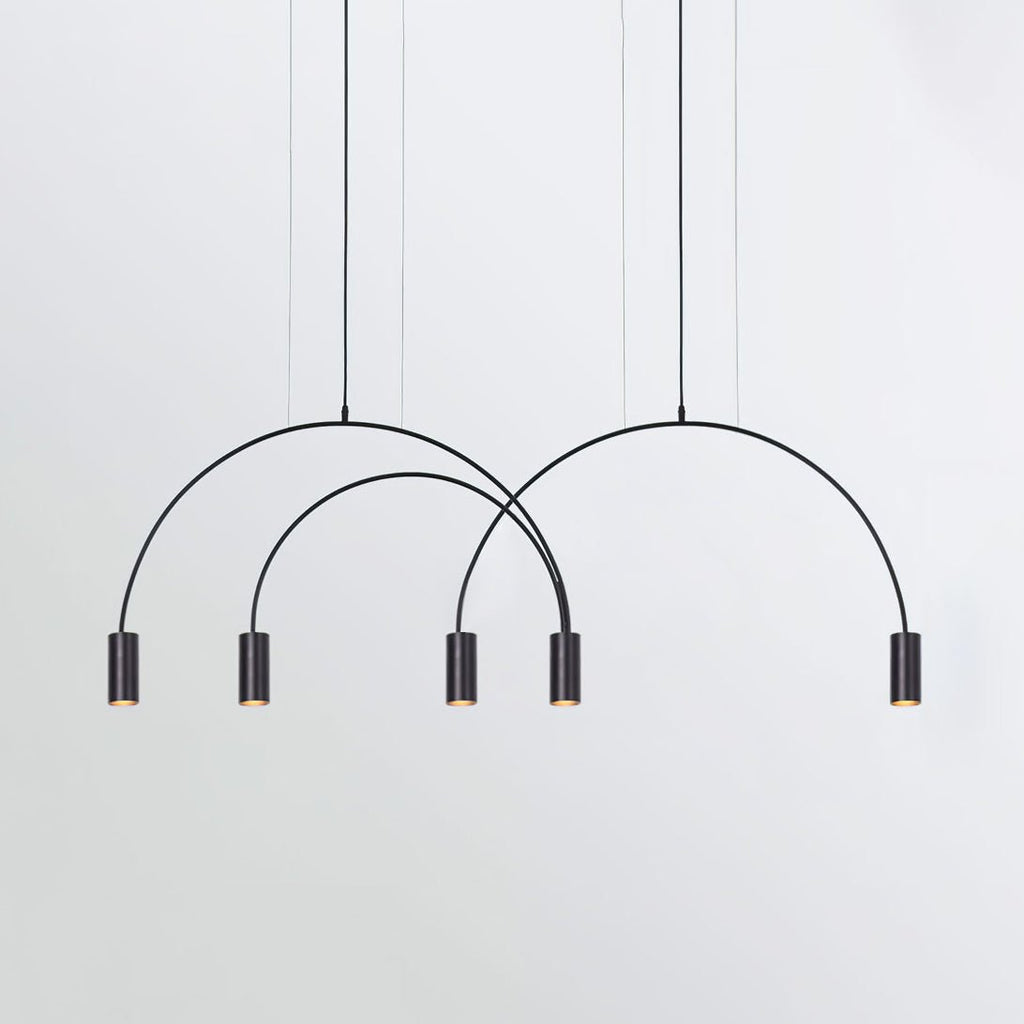 Three black arches carry five dark spot heads on this Clérachic pendant, shown on a pale grey backdrop.