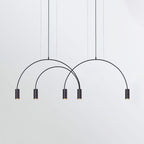 Three black arches carry five dark spot heads on this Clérachic pendant, shown on a pale grey backdrop.