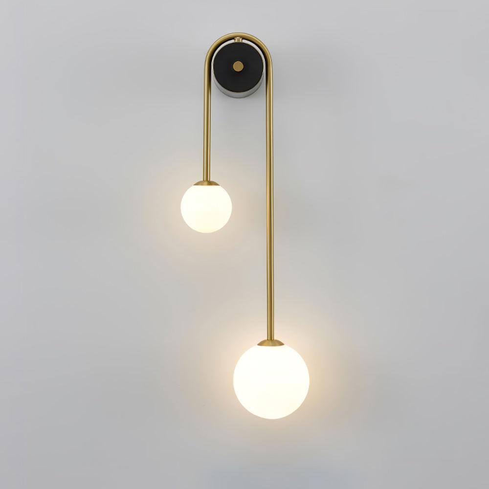 Right-hand version of the Clérachic arched brass wall sconce, its long leg and larger globe falling to the right.