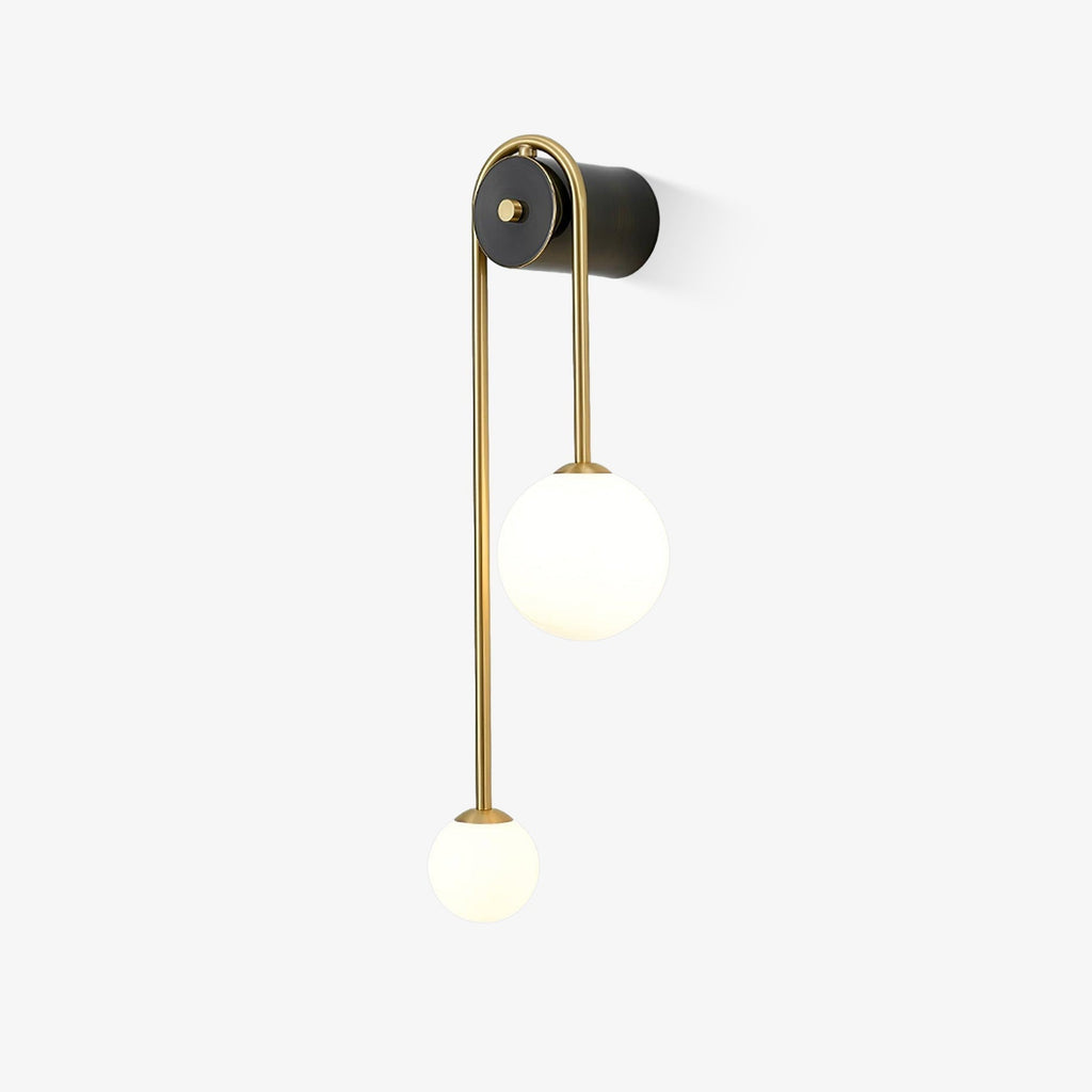 Clérachic arched brass wall sconce on a white background, the matte black cylinder body projecting clear of the wall.