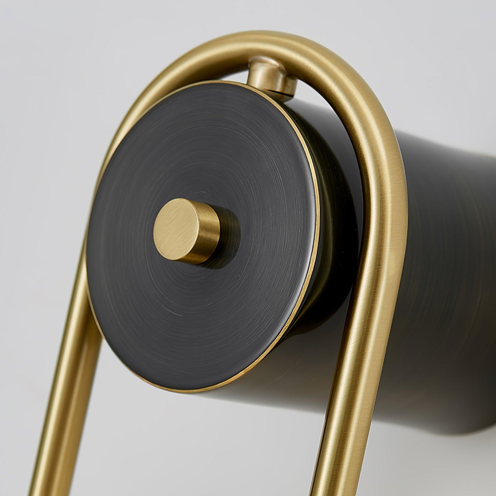 Macro of the Clérachic arched brass sconce's black disc, turned in fine rings around a knurled brass pin.