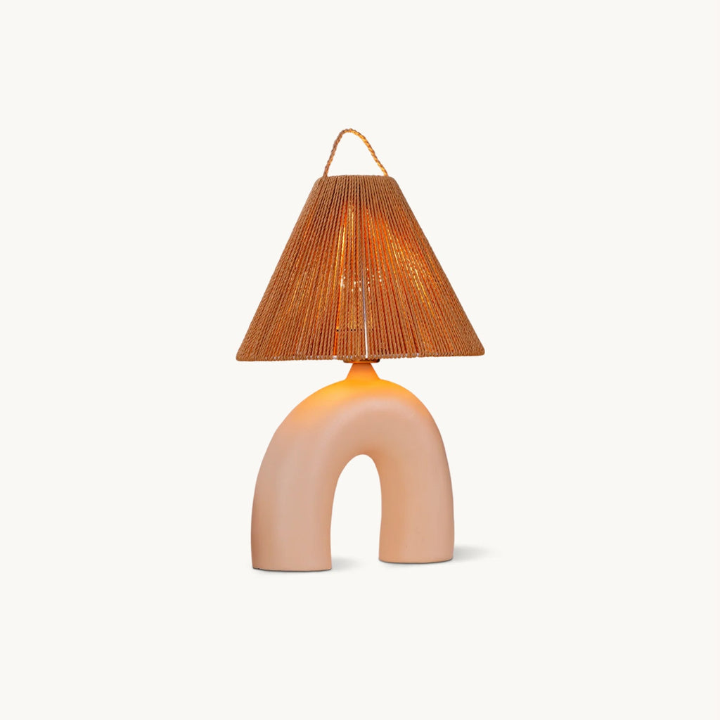 This Clérachic table lamp on a plain off-white backdrop, with an arched Skin ceramic base and a conical rope-wrapped shade.