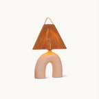 This Clérachic table lamp on a plain off-white backdrop, with an arched Skin ceramic base and a conical rope-wrapped shade.