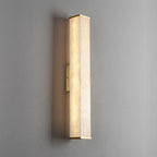 The Clérachic sconce in its squared profile, brass end caps and mounting bar crisp against a soft grey wall.