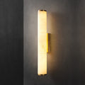 The Clérachic brass sconce seen straight on, alabaster panels showing their natural cloudy veining under warm light.