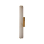 Clérachic alabaster wall sconce on a clean white background, brass collars capping the stone tube top and bottom.