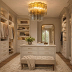 Amber glass Clérachic flush mount above a walk-in wardrobe with a marble-topped island, a tufted bench and an arched mirror.