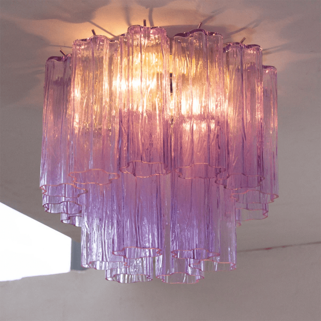 Looking up at the purple art glass tubes of this Clérachic flush mount, lit from within, with the tiers shading to pink at the base.
