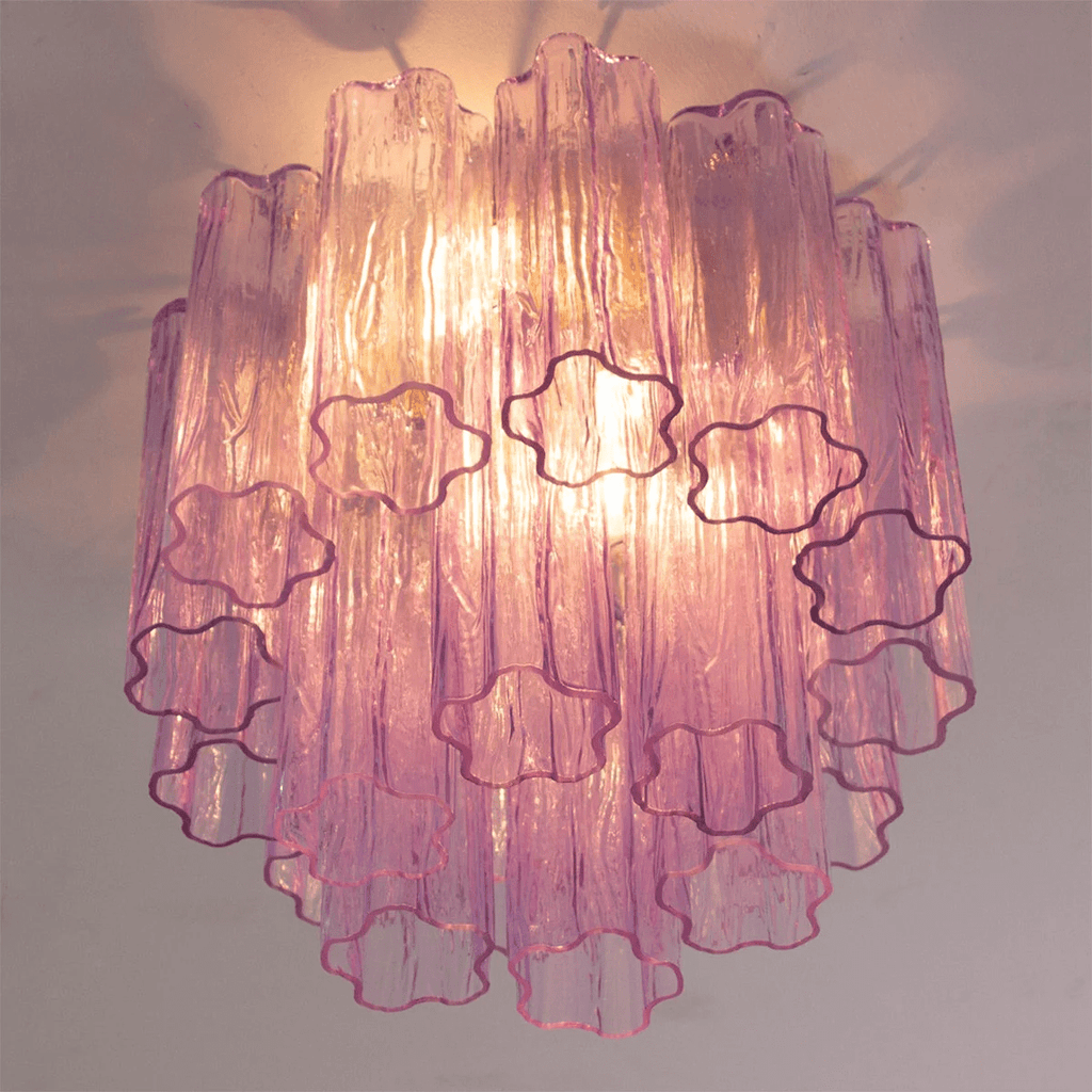 Looking up at the purple and pink glass tubes of this Clérachic flush mount, with the star-shaped ends of the tubes picked out.