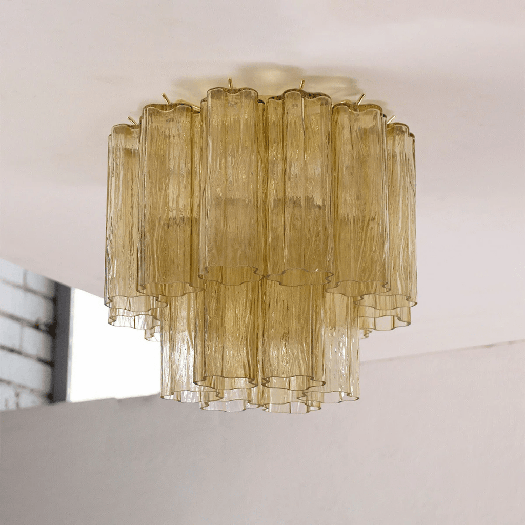 Olive-toned glass Clérachic flush mount with two tiers of textured tubes, hung from a white ceiling.