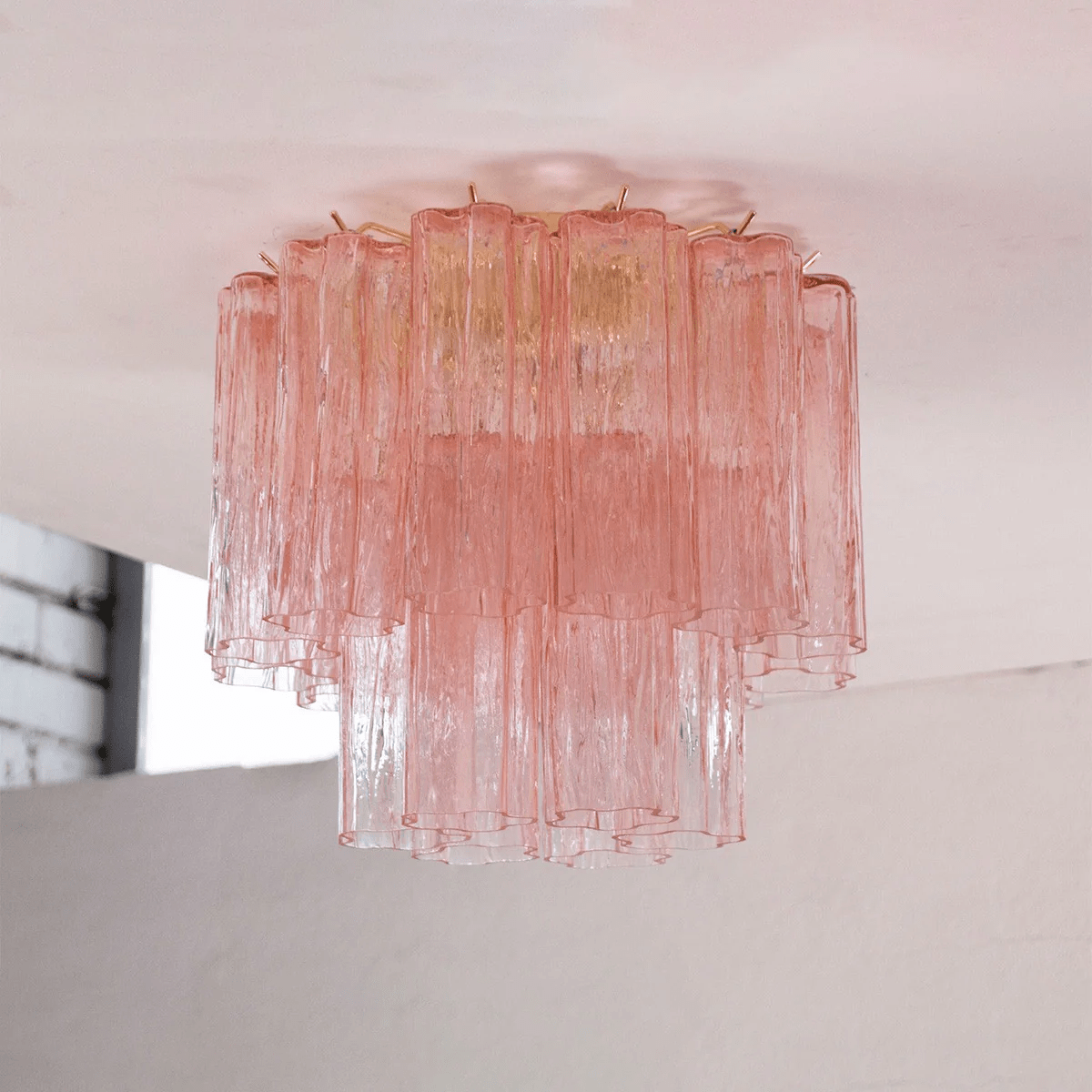 Pink art glass Clérachic flush mount seen from the side, with the pink tubes fading to clear at the bottom tier.