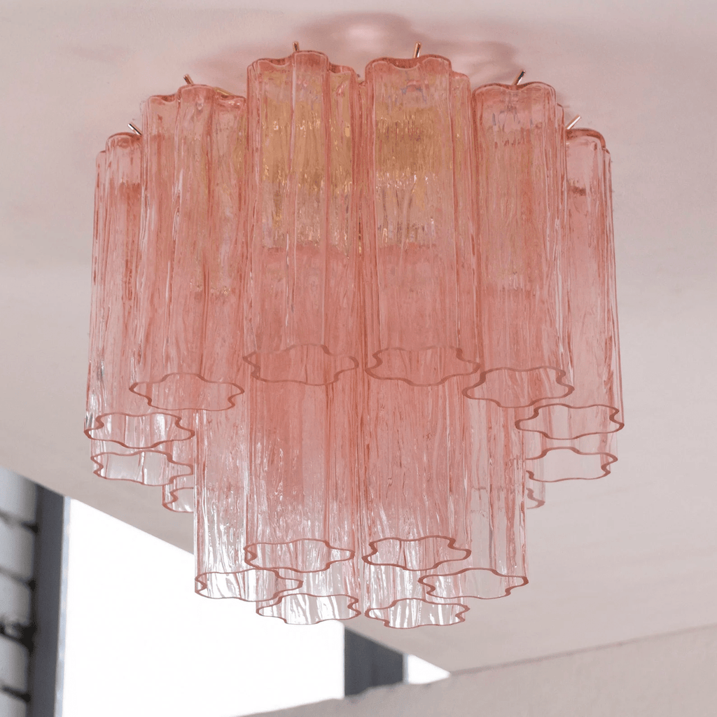 Looking up at the pink glass tubes of this Clérachic flush mount, fading from rose at the top to clear at the base.