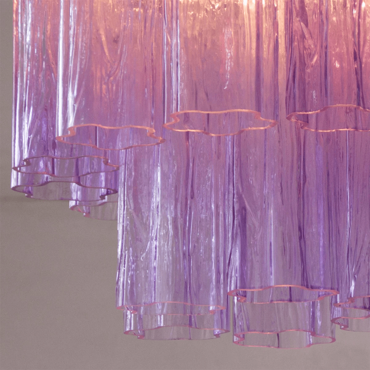 Close view of the purple art glass tubes on this Clérachic flush mount, with their wavy, star-shaped open ends.