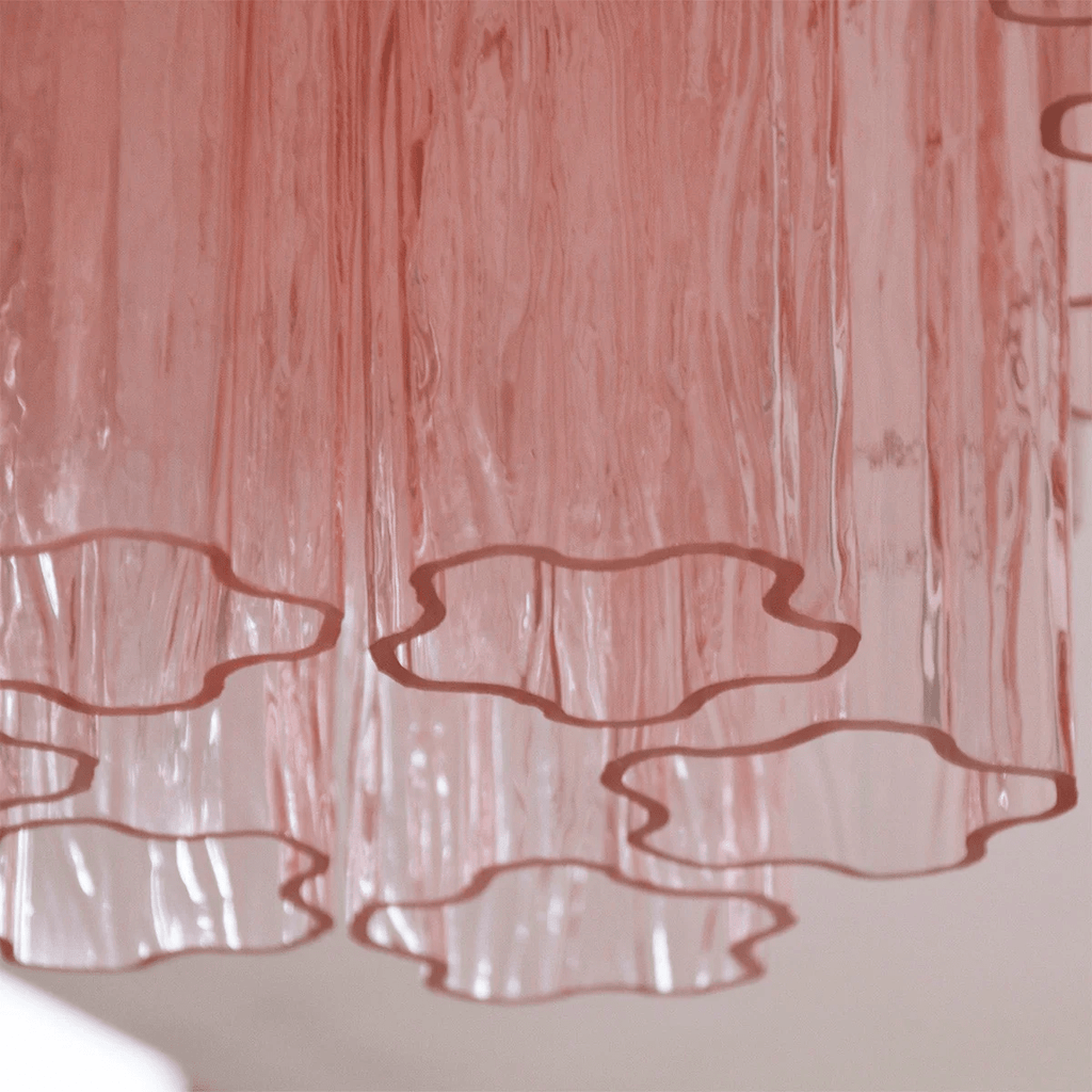 Close view of the textured pink glass tubes on this Clérachic flush mount, with the open ends edged in a deeper rose.