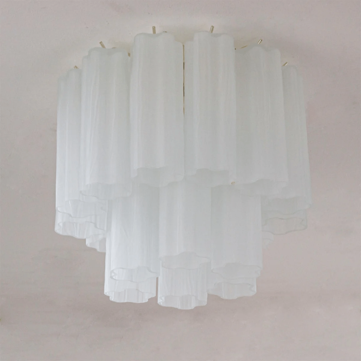 White frosted glass Clérachic flush mount with two tiers of tubes, unlit on a pale ceiling.