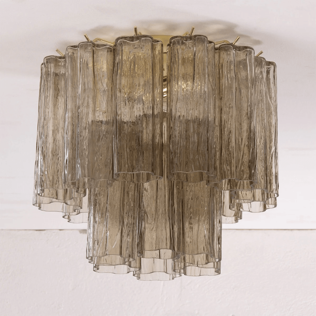 Smoky grey glass Clérachic flush mount with textured tubes in two tiers, seen against a white ceiling.