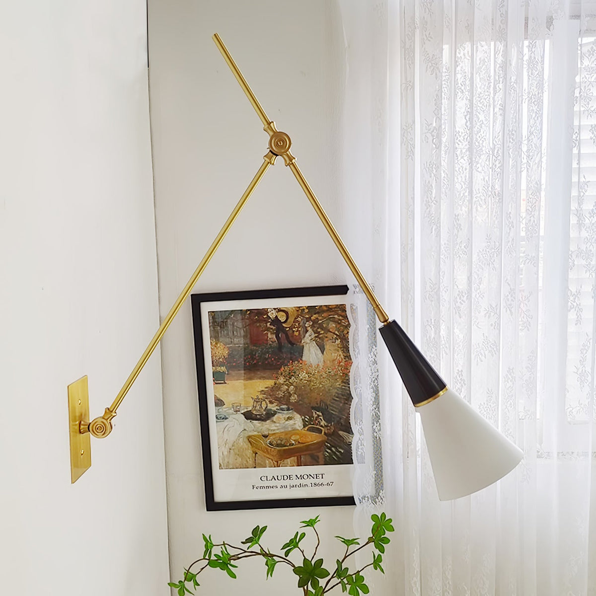 Clérachic wall light with a wide arm angle beside sheer lace curtains, its white cone shade turned down towards a framed print.