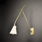 Clérachic wall light with a white cone shade and brass arms on a dark grey wall, the arms making a wide V from the backplate.