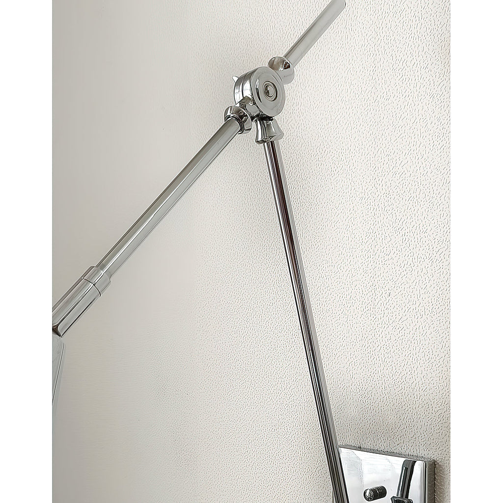 Close view of the bright nickel arm joint on this Clérachic wall light, with one arm leaving the frame on a pale wall.