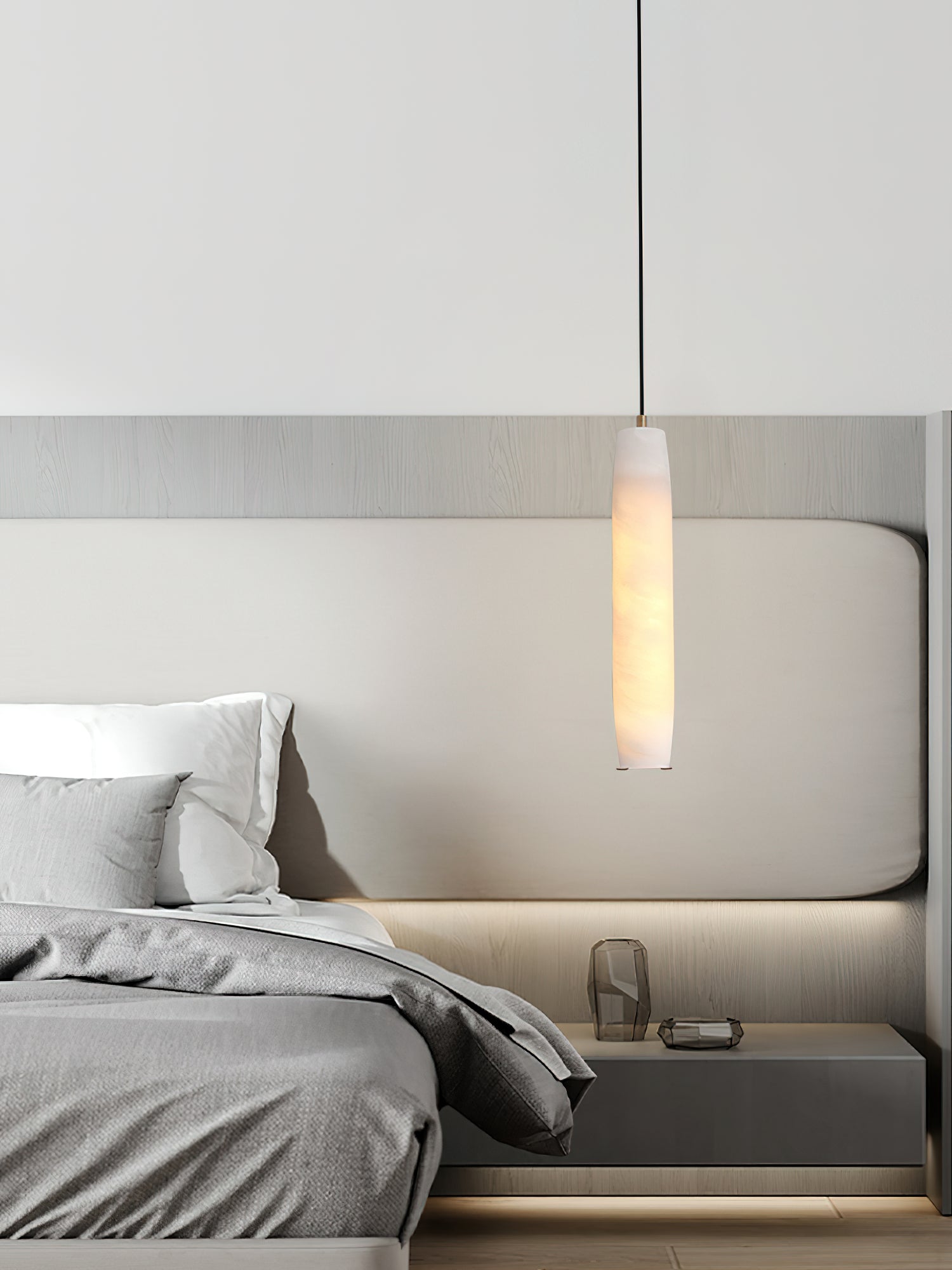 Clérachic lights a pale wood bedroom, the Asbury pendant casting a warm pool across a low floating nightstand.