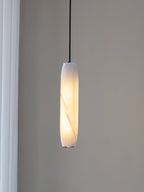 Clérachic frames the Asbury close up against a pale wall, the diagonal vein in its alabaster shade catching the light.