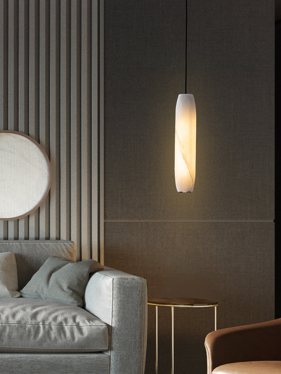The Clérachic Asbury lights a living room of fluted timber panelling, above a grey sofa and a brass-legged side table.