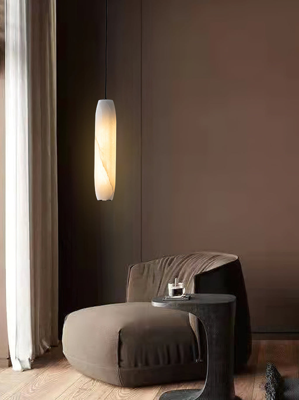 The Clérachic Asbury glows in a plum-toned lounge, above a curved boucle chair and a dark stone side table.