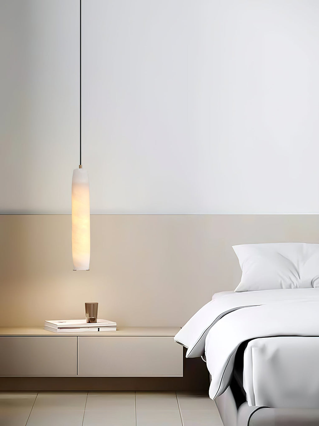 The Clérachic Asbury hangs in a bright minimal bedroom, lighting a low white console beside crisp white bedding.