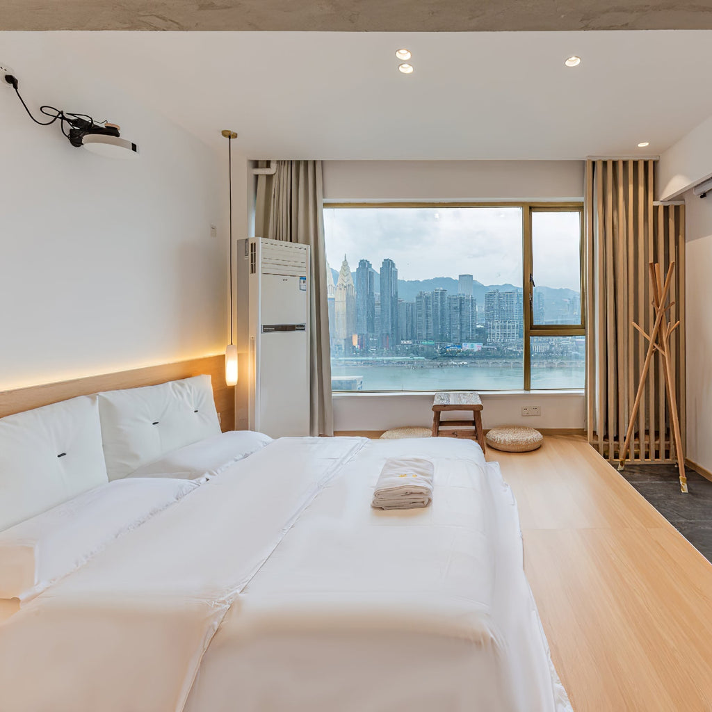 Clérachic fits the Asbury in a hotel-style bedroom, its warm light beside a wide window looking out over the city.