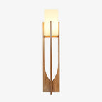 Floor lamp from Clérachic on a white backdrop, its shade lit warm and its frame in a mid-toned natural wood.