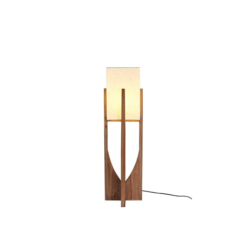 Medium-height Clérachic floor lamp in dark wood with a cream shade and a coiled black cord, on a white backdrop.