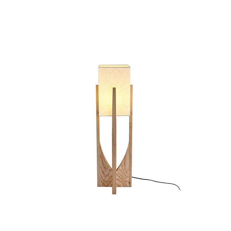 Medium-height Clérachic floor lamp in a lighter ash finish with a lit shade and a black cord, on a white backdrop.