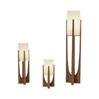 Three Clérachic lamps in different heights on a white backdrop, the tallest on the right, all with unlit fabric shades.