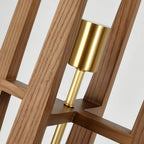 Close view of the wooden frame joints, the brass bulb holder and the brass rod inside this Clérachic floor lamp.