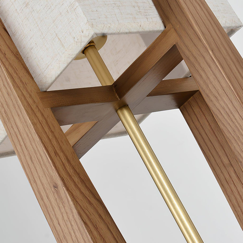 Looking up into the frame of this Clérachic lamp, with a brass rod, a cross-shaped wooden brace and the base of the shade above.