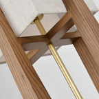 Looking up into the frame of this Clérachic lamp, with a brass rod, a cross-shaped wooden brace and the base of the shade above.