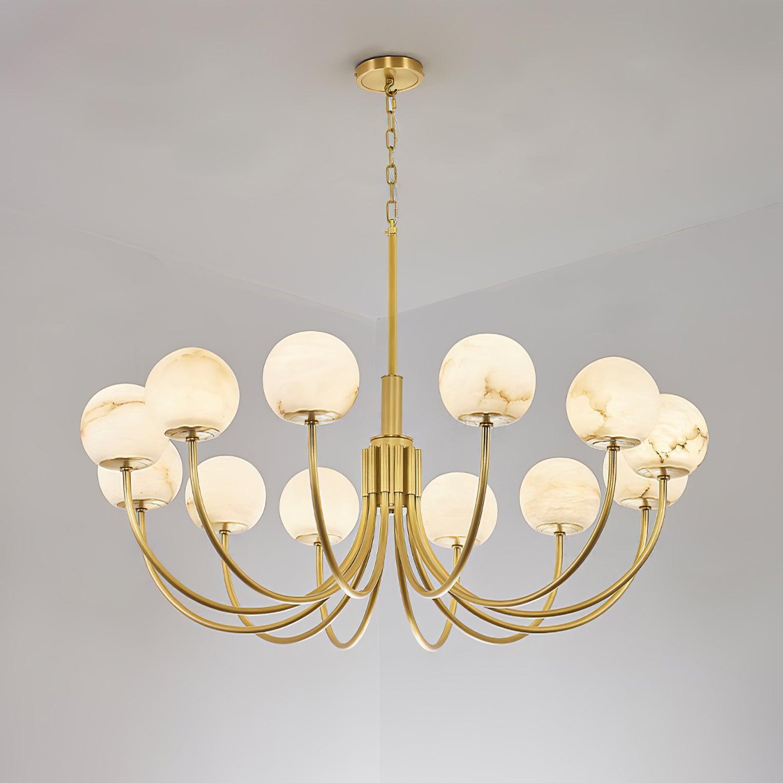 Clérachic Aurelian chandelier viewed from below, brass arms radiating from the fluted column.