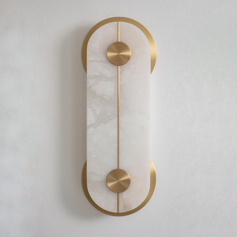 The Clérachic Auriel shows the veining in its alabaster panel, held top and bottom by brushed brass crescents against an off-white wall.