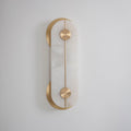 Clérachic wall light in its compact size, the alabaster slab lit by daylight so its soft grey veining reads against white plaster.