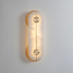 Clérachic Auriel switched on in a pale room, its integrated LED washing the alabaster with a soft honey glow.