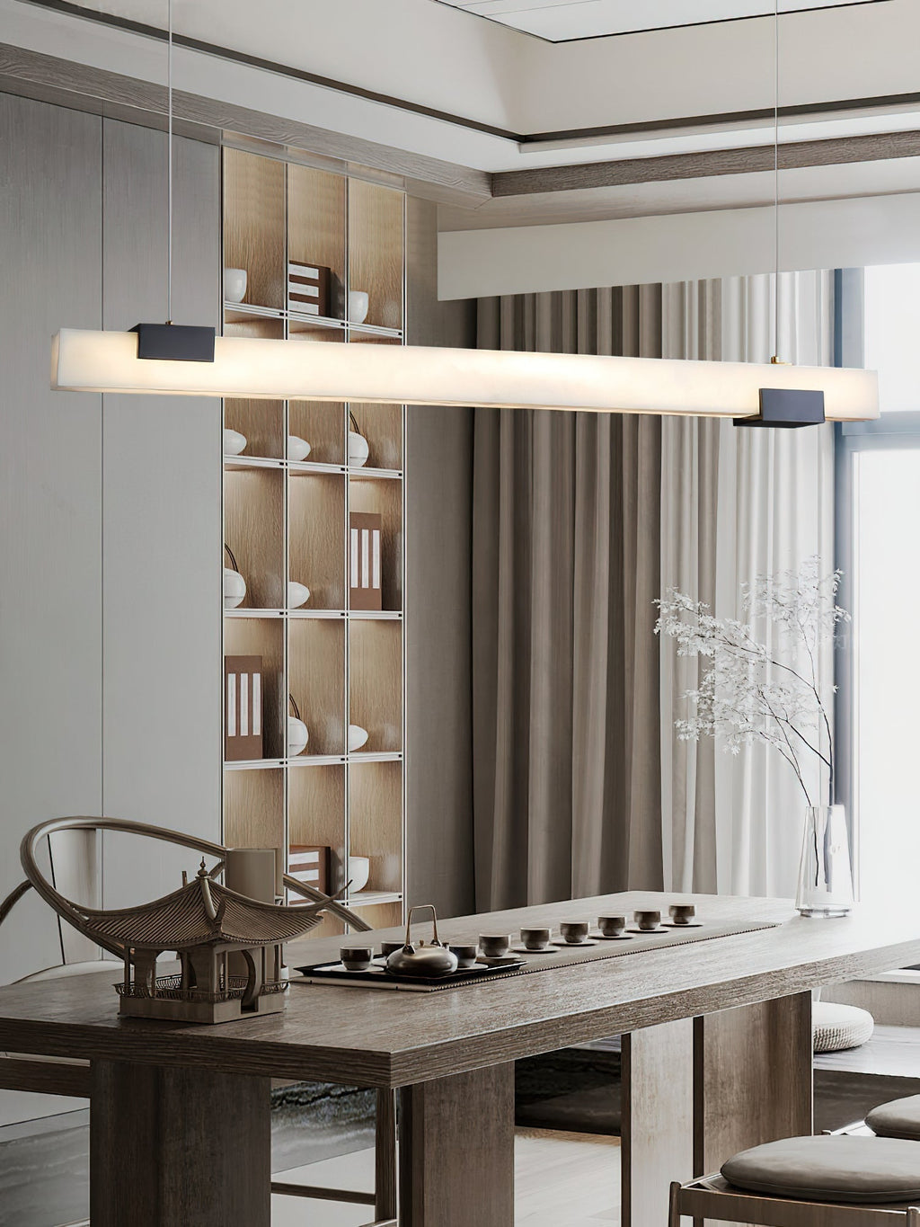 The Clérachic Avert lights a long tea table, its lit bar echoing the pale ceramics on the shelving behind.