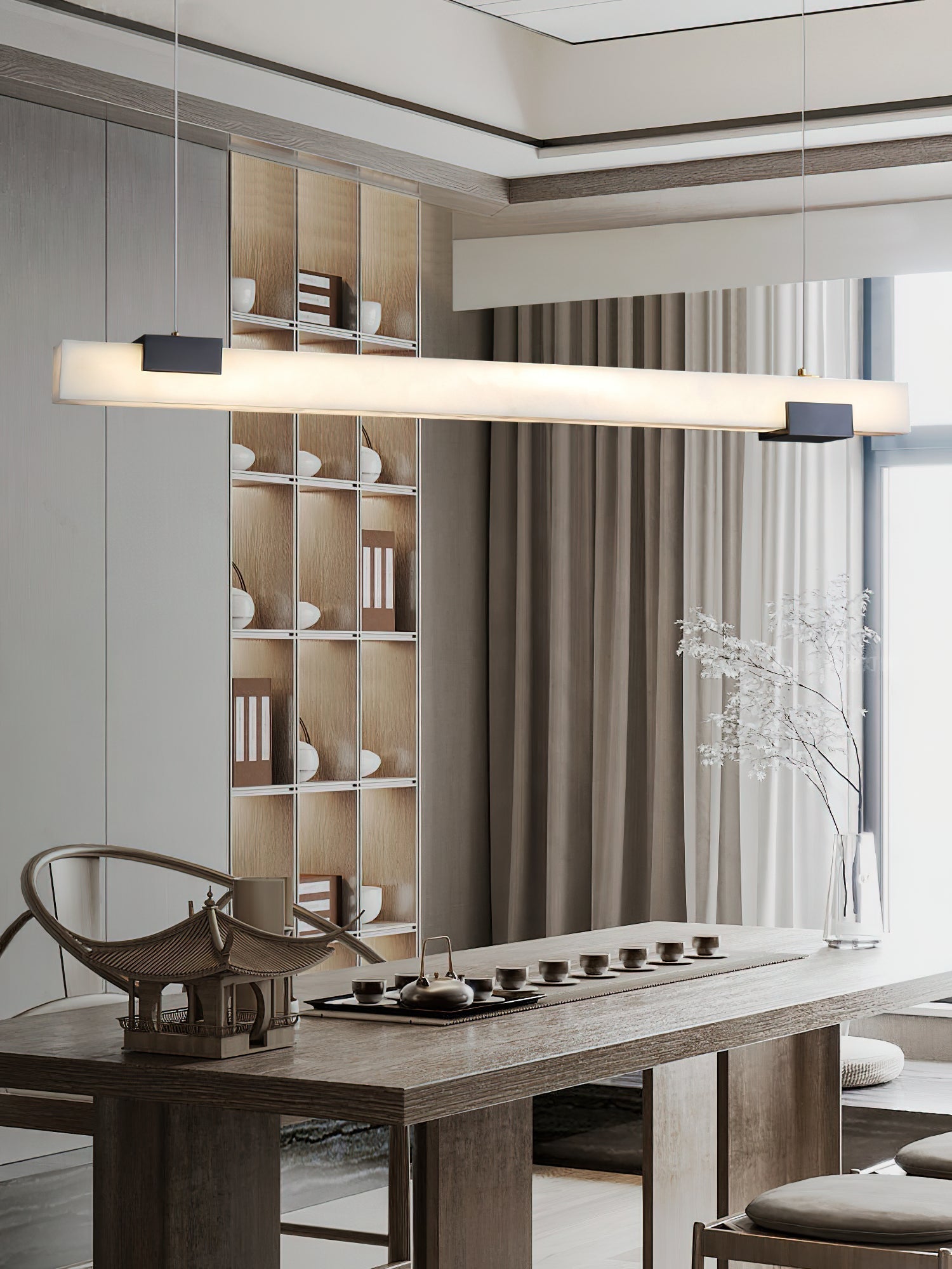 The Clérachic Avert lights a long tea table, its lit bar echoing the pale ceramics on the shelving behind.