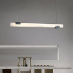Clérachic Avert casting an even line of light across a marble counter set with brass tea ware.