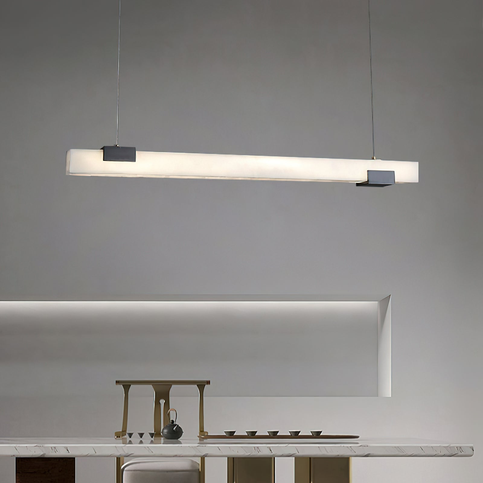 Clérachic Avert casting an even line of light across a marble counter set with brass tea ware.