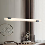 The Clérachic Avert above a dining table, its light grazing the timber panelling and round wall medallion behind.