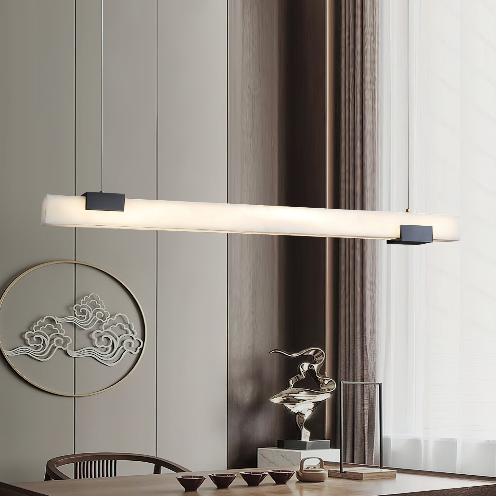 The Clérachic Avert above a dining table, its light grazing the timber panelling and round wall medallion behind.