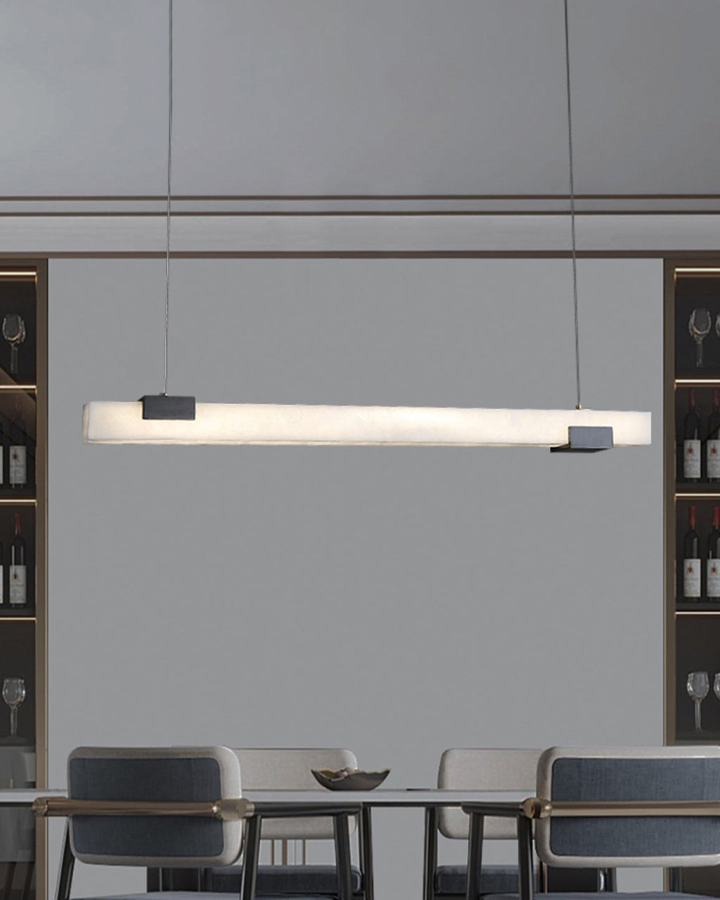 The Clérachic Avert lit above a dining table backed by glass-fronted wine cabinets and upholstered chairs.