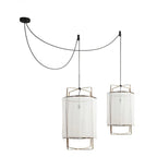 The same twin-swag pair in a sheer white gauze shade, with the bare bulbs showing through